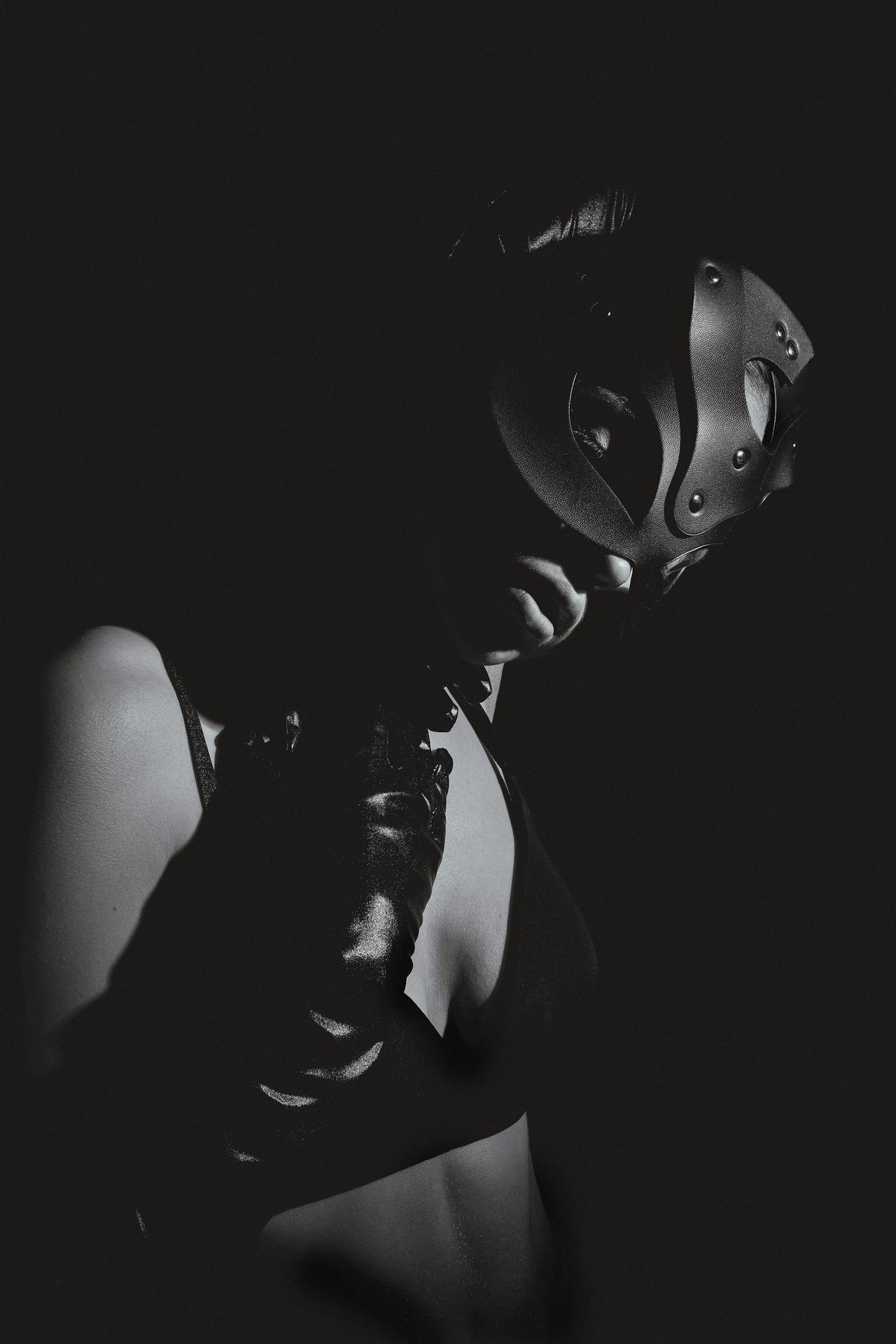 A black and white photo of a woman wearing a mask