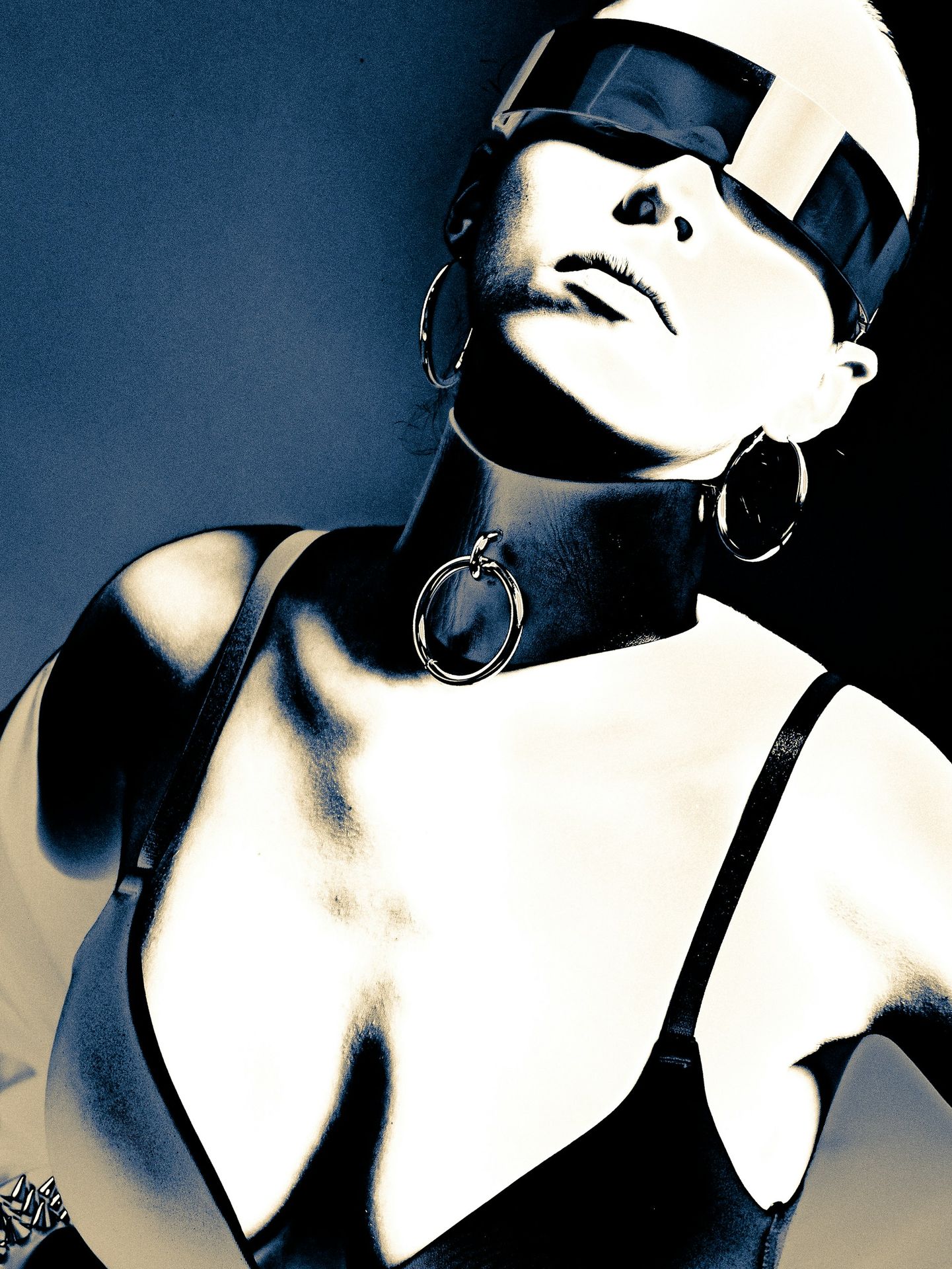 Woman wearing futuristic sunglasses and choker necklace